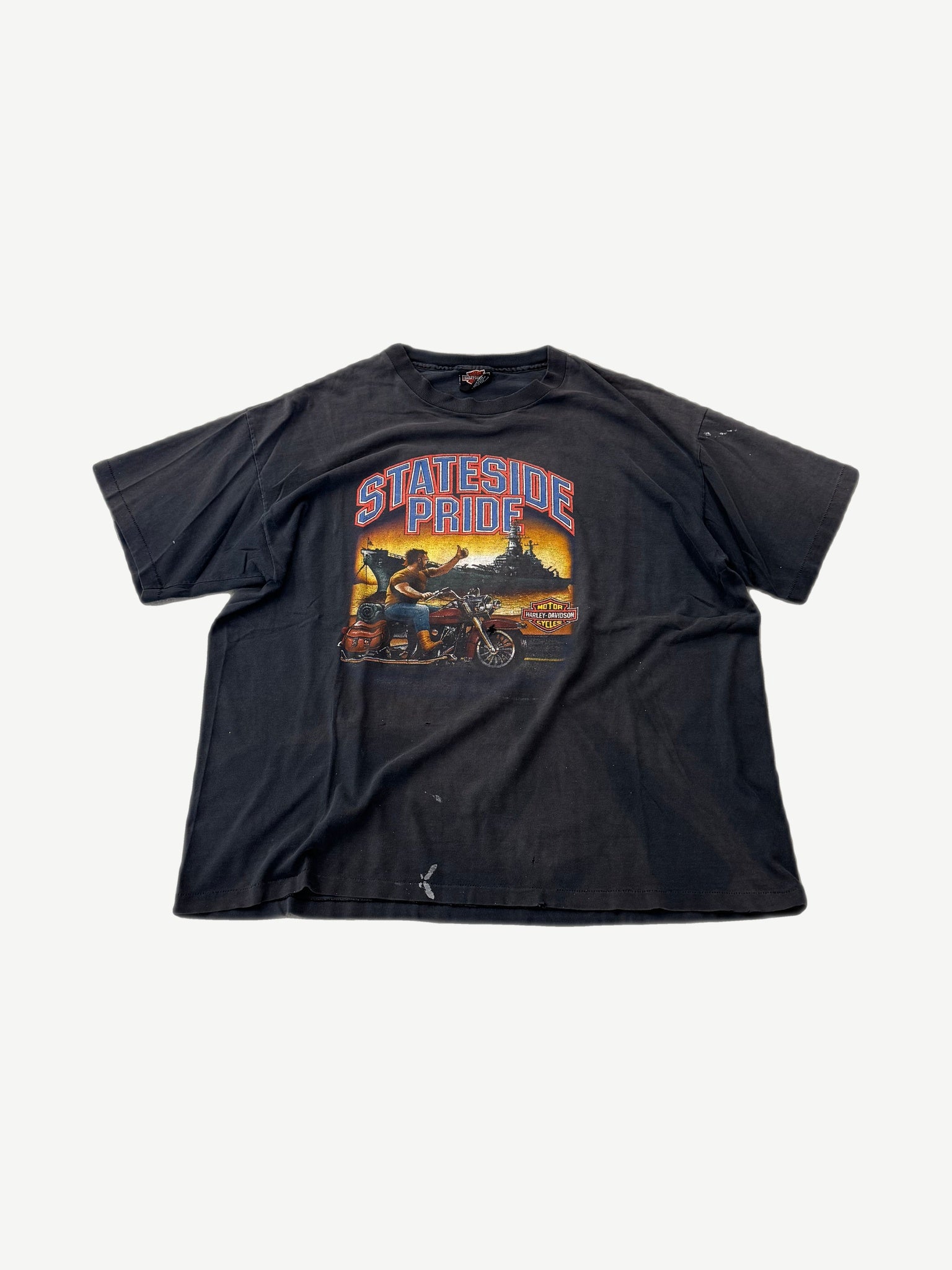 Vintage Harley Davidson Stateside Pride faded black tee front with biker saluting battleship sunset graphic