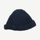 Back view of Paly Hollywood blue hand-knit beanie showing ribbed chunky cable texture and rolled cuff.