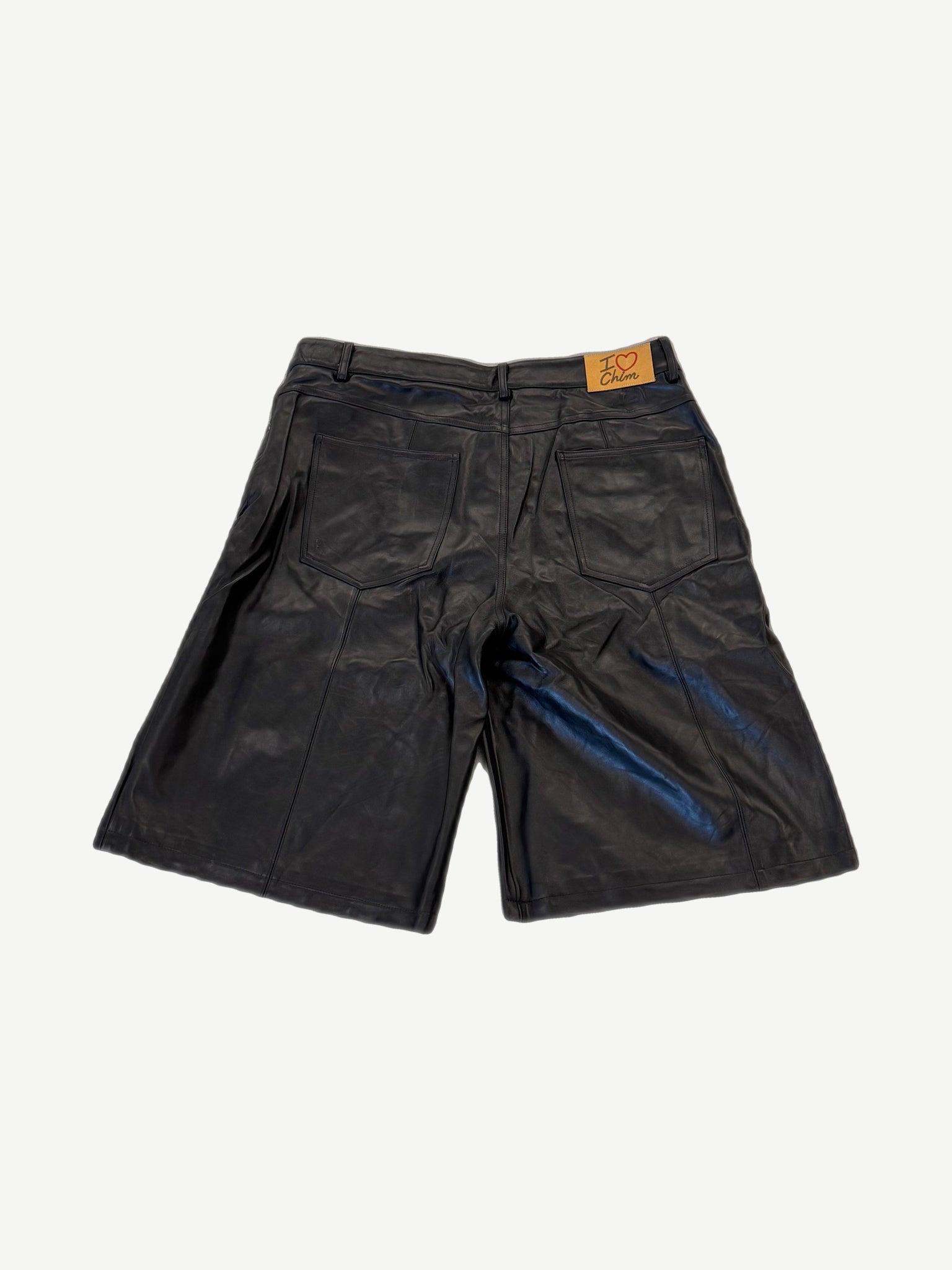 HMDD black leather lamb chop shorts back, I heart Chim leather waistband tag above twin patch pockets.