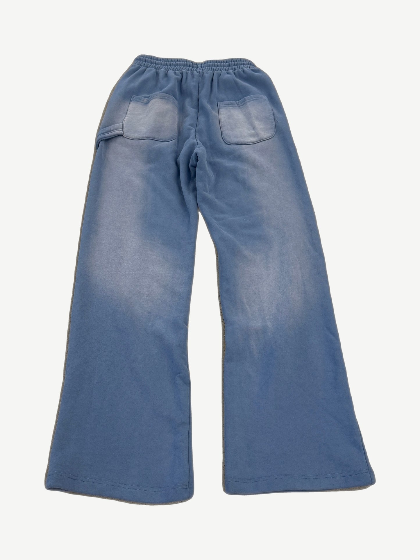 Back view of HMDD light blue washed sweatpants with twin patch pockets and faded sun-bleached finish