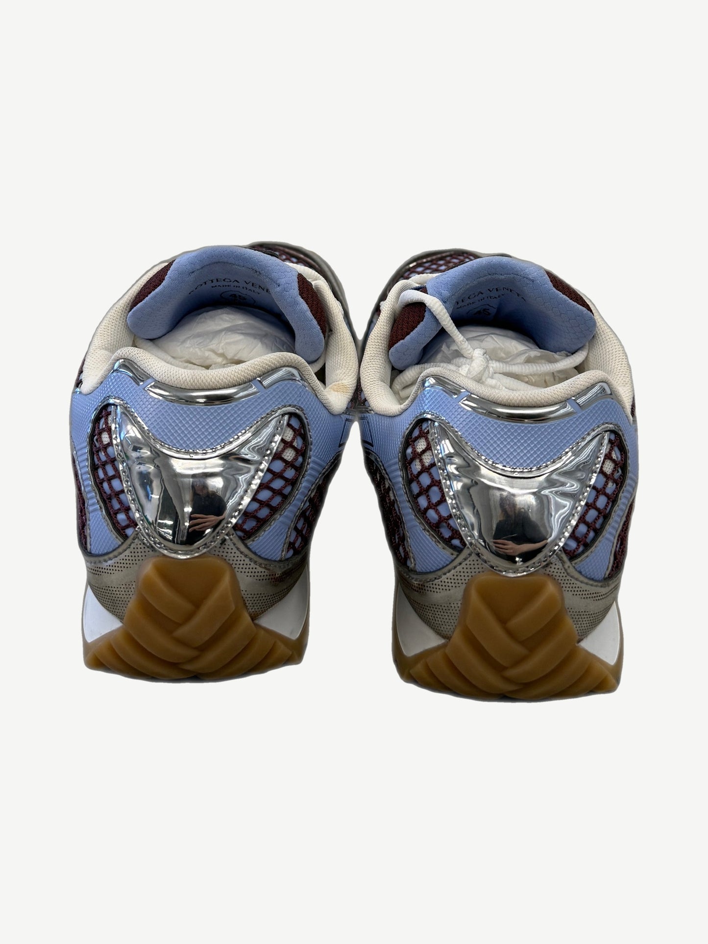 Bottega Veneta Orbit sneakers heel view with chrome silver heel cup and chunky gum rubber sole.
