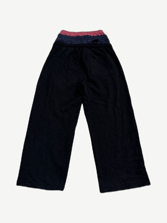 Back of Project GR black layered sweatpants showing triple stacked waistbands and patch pocket detail