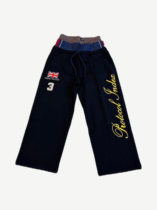 Protocol Index black wide leg layered sweatpants front with Union Jack patch and cursive leg script.