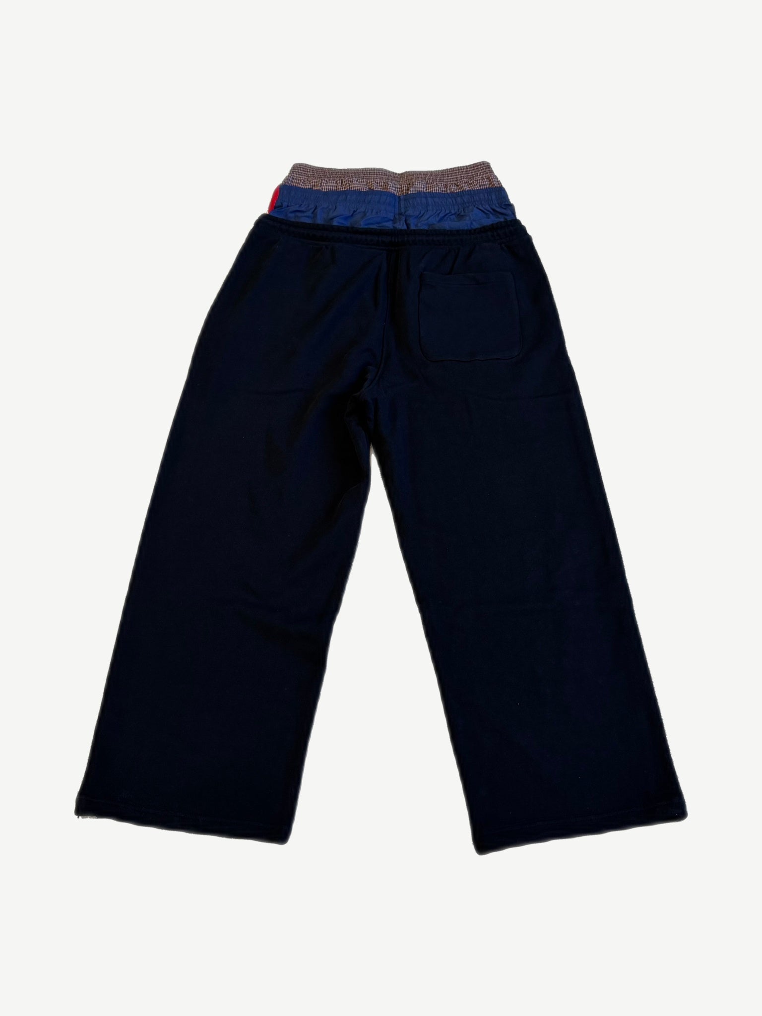 Protocol Index black layered sweatpants back with contrast plaid waistband detail and patch rear pocket.