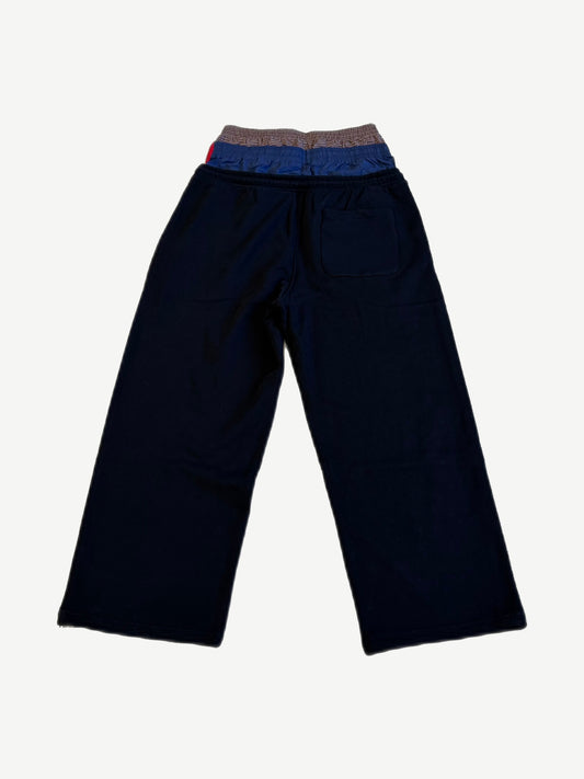 Protocol Index black layered sweatpants back with contrast plaid waistband detail and patch rear pocket.