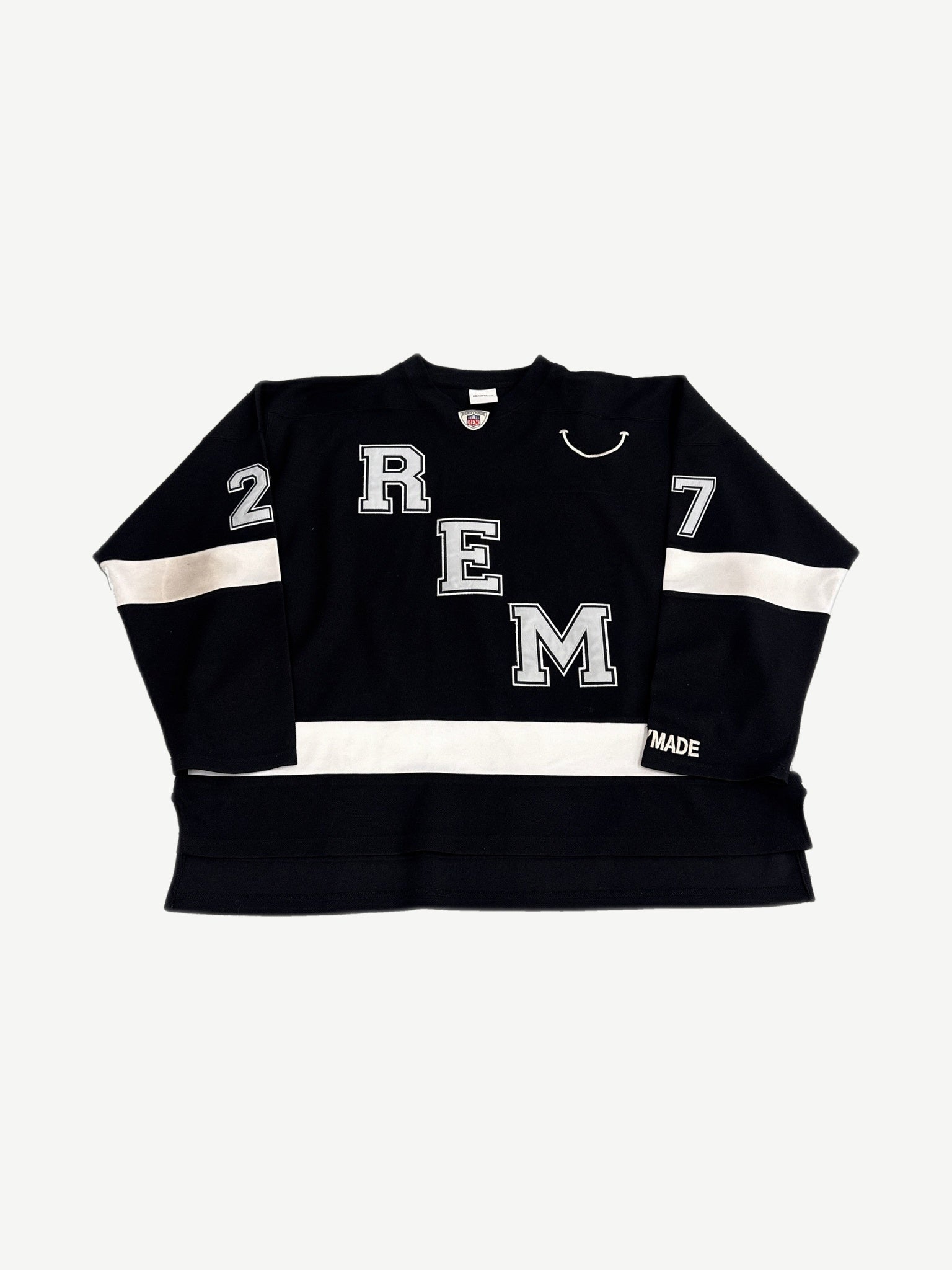 Readymade black hockey jersey front with REM letter applique, smile graphic and white sleeve stripes