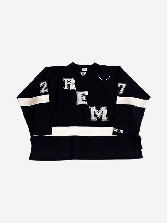 Readymade black hockey jersey front with REM letter applique, smile graphic and white sleeve stripes