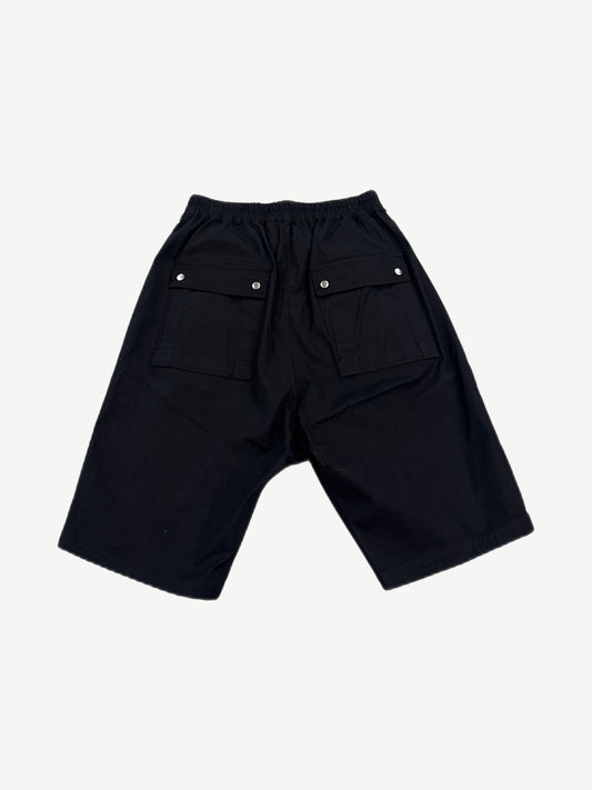 Rick Owens black Bela cargo shorts back view showing dropped seat, snap closures and tapered hem.