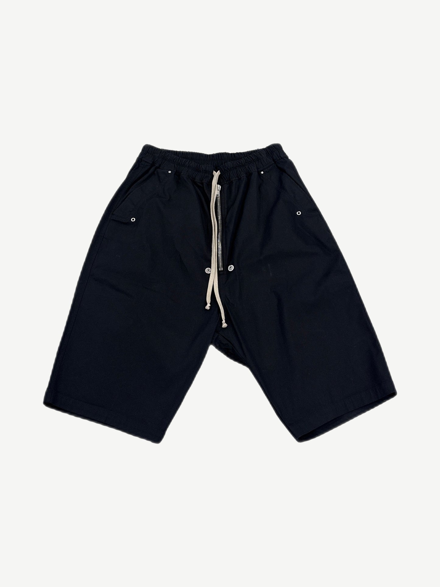 Rick Owens black Bela drop-crotch cargo shorts with drawstring waist and side snap pockets, front view.