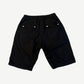 Rick Owens Bela Pods shorts back view in black cotton with twin flap pockets and snap closures.