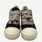Front view of Rick Owens DRKSHDW black sneakers showing thick cream jumbo laces and oversized tongue