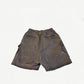 Rick Owens DRKSHDW Dust Bela shorts, back view showing elastic waist and welt pockets on faded fabric