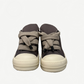 Rick Owens DRKSHDW Dust low puffer sneaker side profile with chunky outsole and exaggerated lace bow