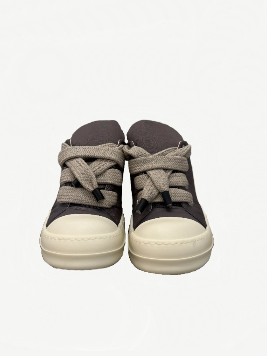 Rick Owens DRKSHDW Dust low puffer sneaker side profile with chunky outsole and exaggerated lace bow