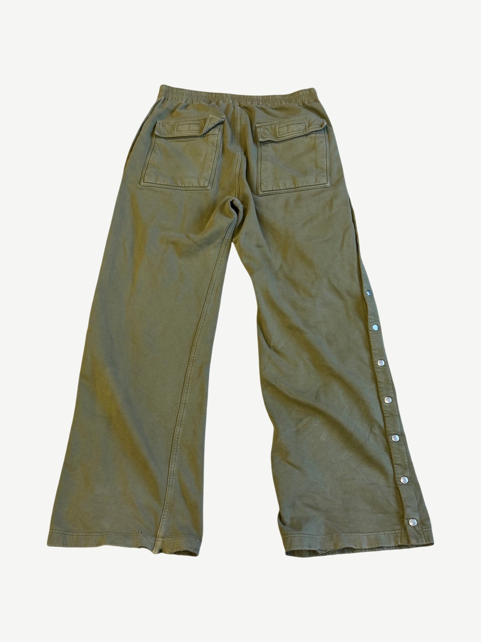 Back of Rick Owens DRKSHDW sage Pusher pants showing flap patch pockets and side popper button placket