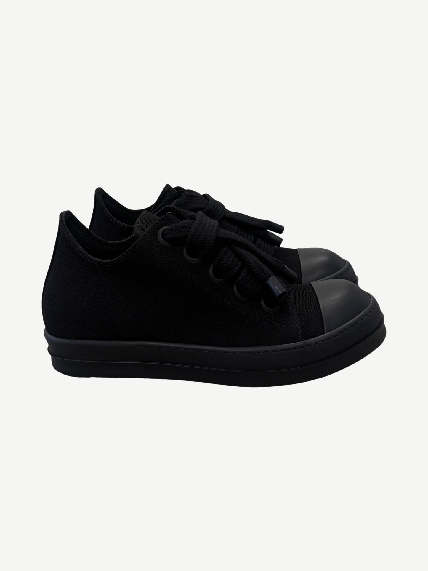 Rick Owens DRKSHDW triple black low top sneakers side view with jumbo laces and rubber cap toe