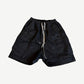Rick Owens Bela waxed black denim cargo shorts with drawstring waist and angled side cargo pockets
