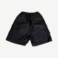 Rick Owens Bela waxed black cargo shorts back view with welt pockets and elastic waistband