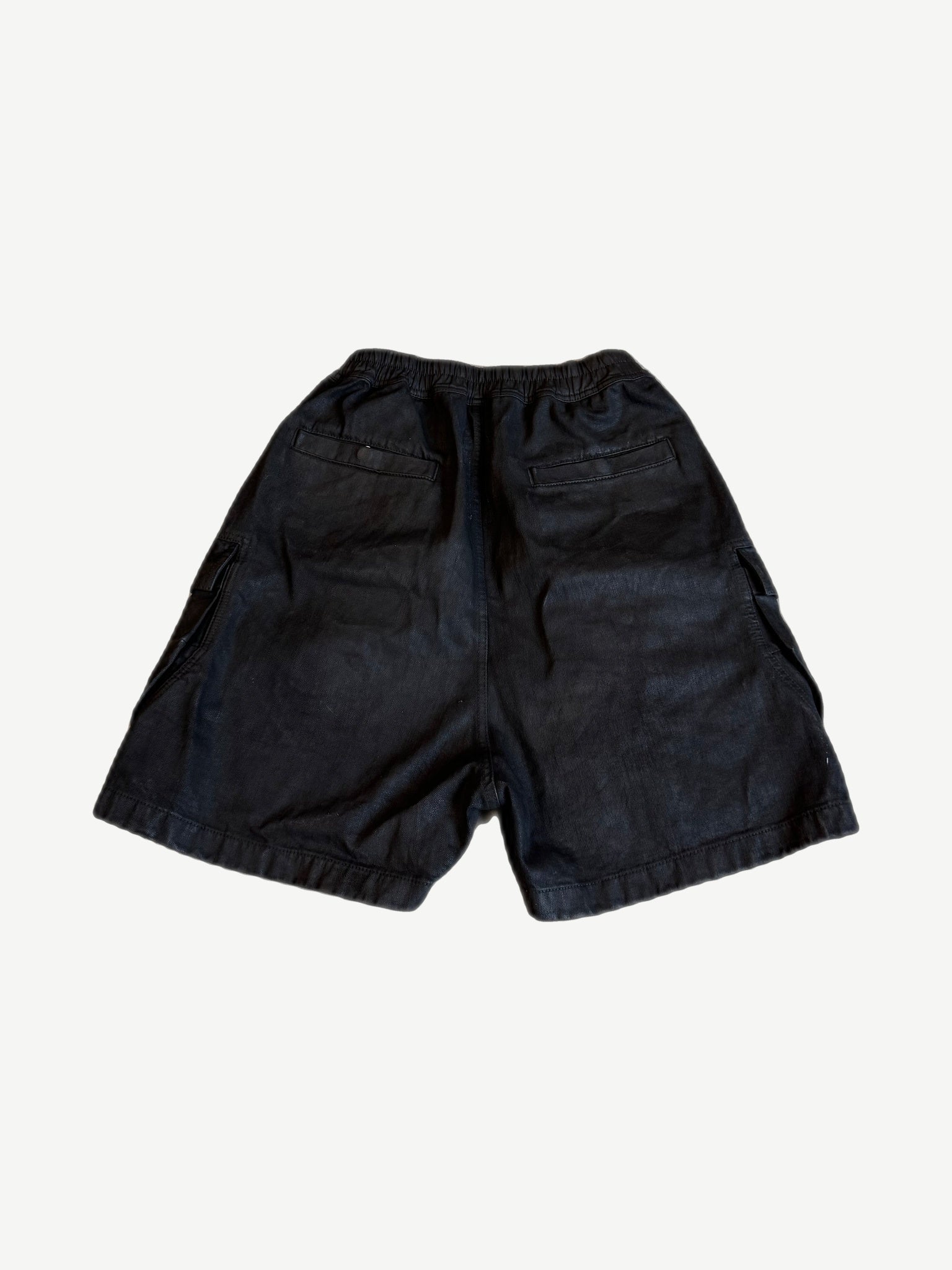 Rick Owens Bela waxed black cargo shorts back view with welt pockets and elastic waistband