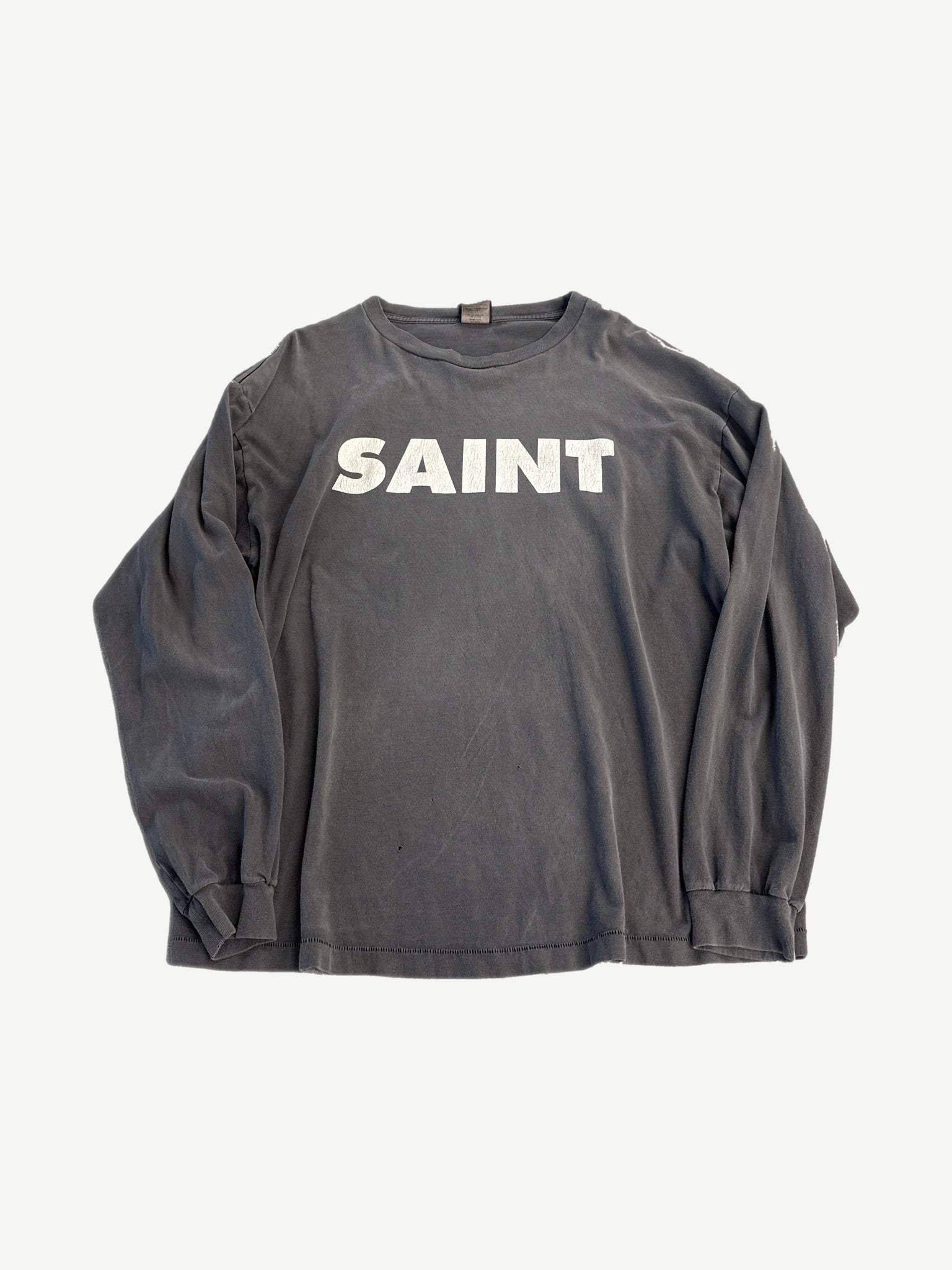 Saint Michael gray long sleeve tee with bold black SNT logo across the chest, ribbed crew neck and cuffs.