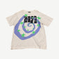 Saint Michael cream Humanity tee front with blue spiral and green stars photo-collage graphic