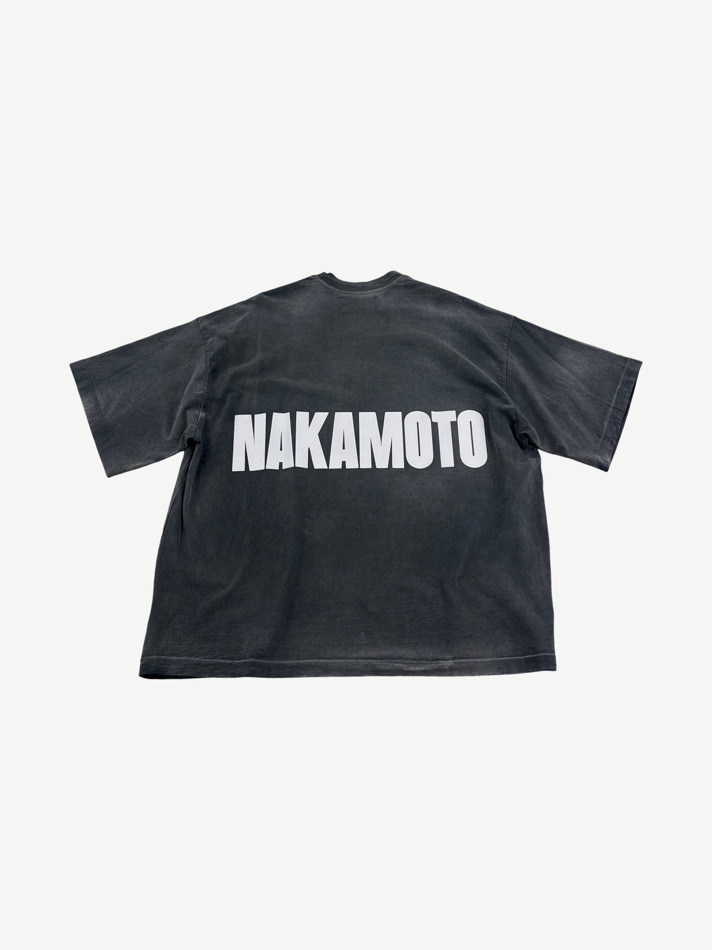 Satoshi Nakamoto Black Impact logo tee back view in sun-faded black cotton with NAKAMOTO white back print.