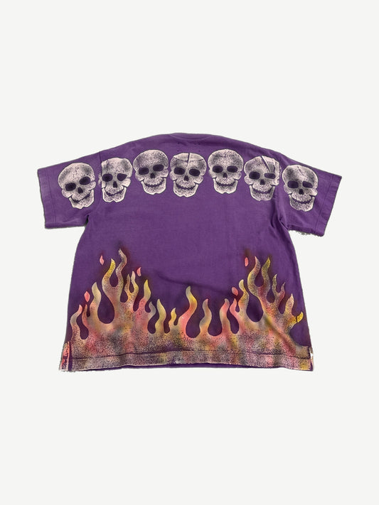 Satoshi Nakamoto purple Lost Boys tee back with skull row print and orange flame airbrush detail.