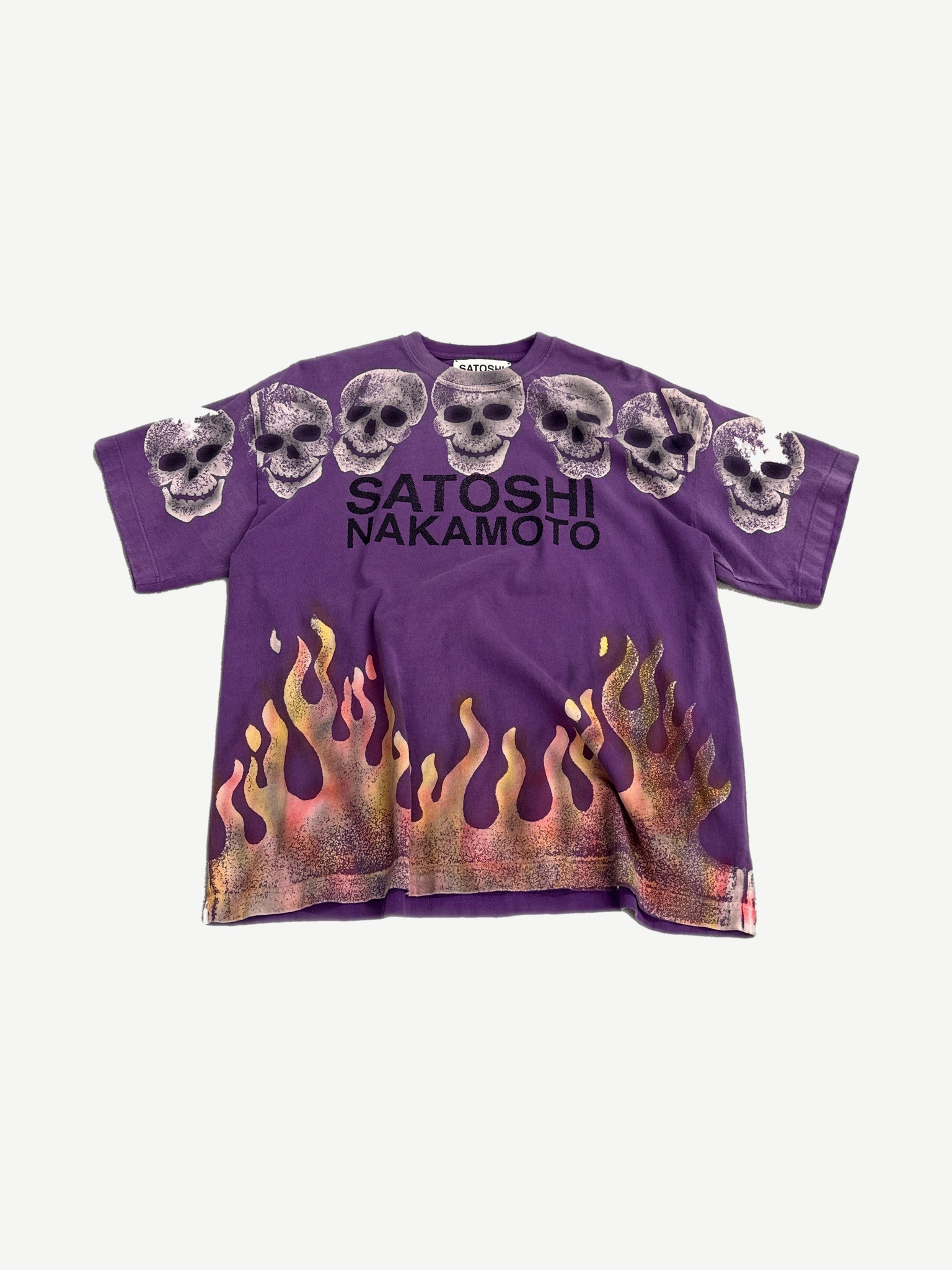 Satoshi Nakamoto purple tee front with row of rhinestone skulls and orange airbrushed flames hem.