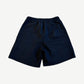 Satoshi Nakamoto navy studded shorts back view with rear patch pocket and elastic ribbed waistband.