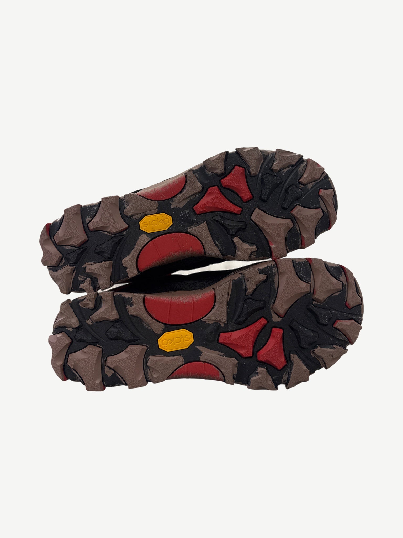 Sicko x 424 hiking shoes outsole view showing aggressive chunky tread with red accents and Sicko stamps