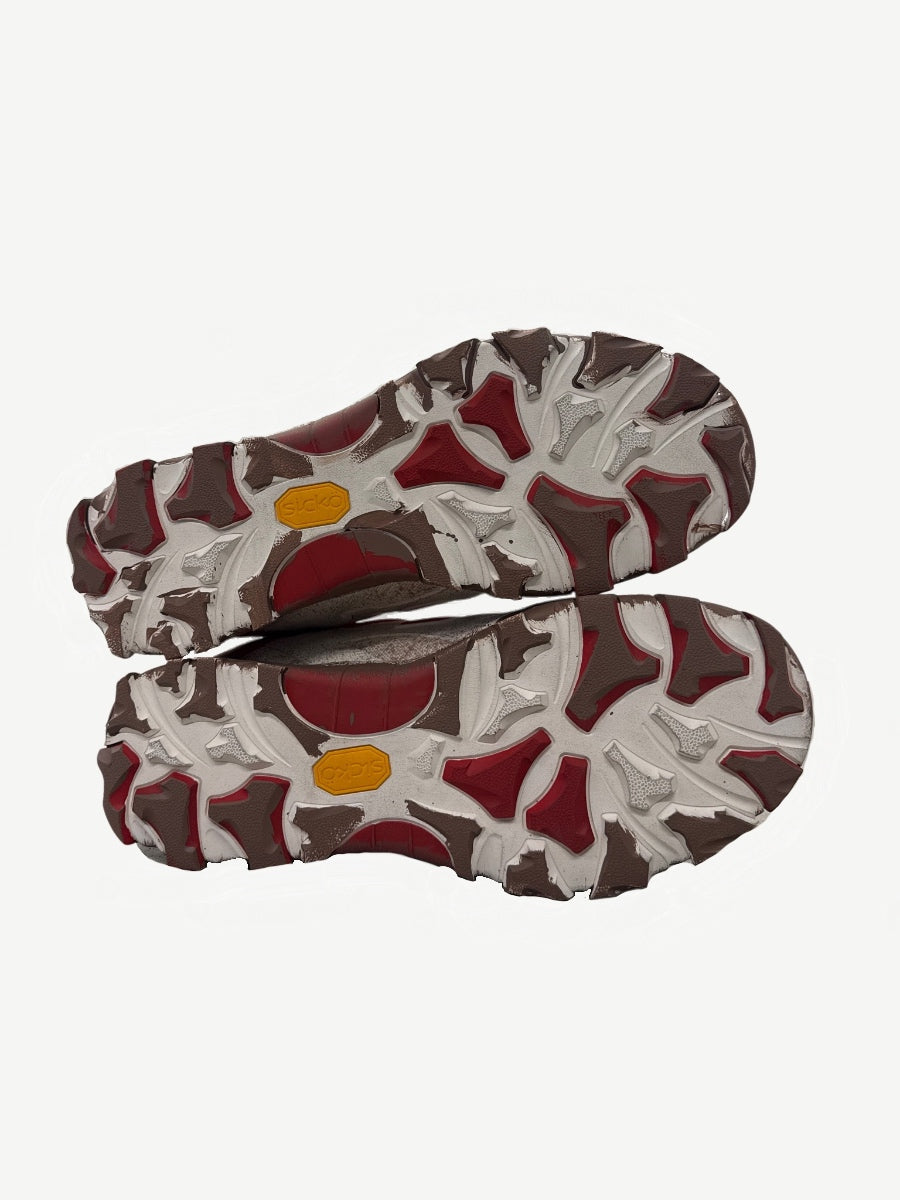 Sicko x 424 hiking shoes outsole view showing chunky trail lug pattern with yellow Sicko branding tabs.
