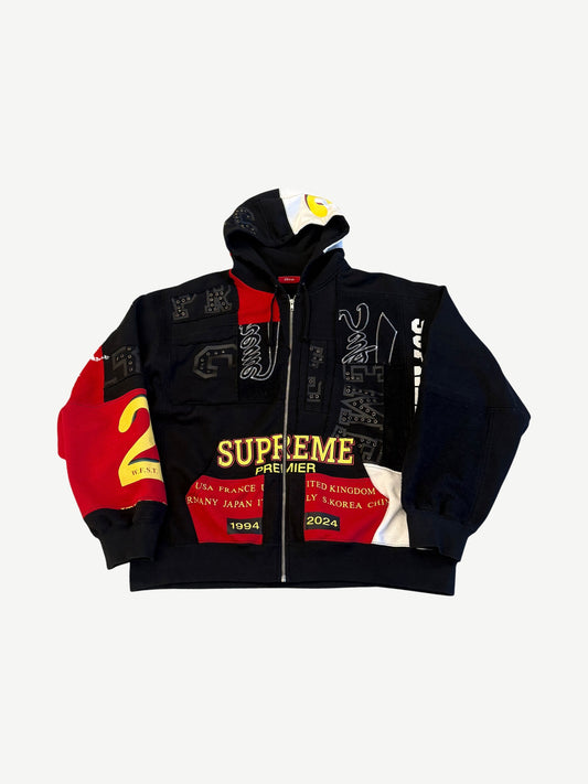 Supreme Premier black patchwork zip up hoodie with red, white and yellow logo panels and 1994-2024 patch.