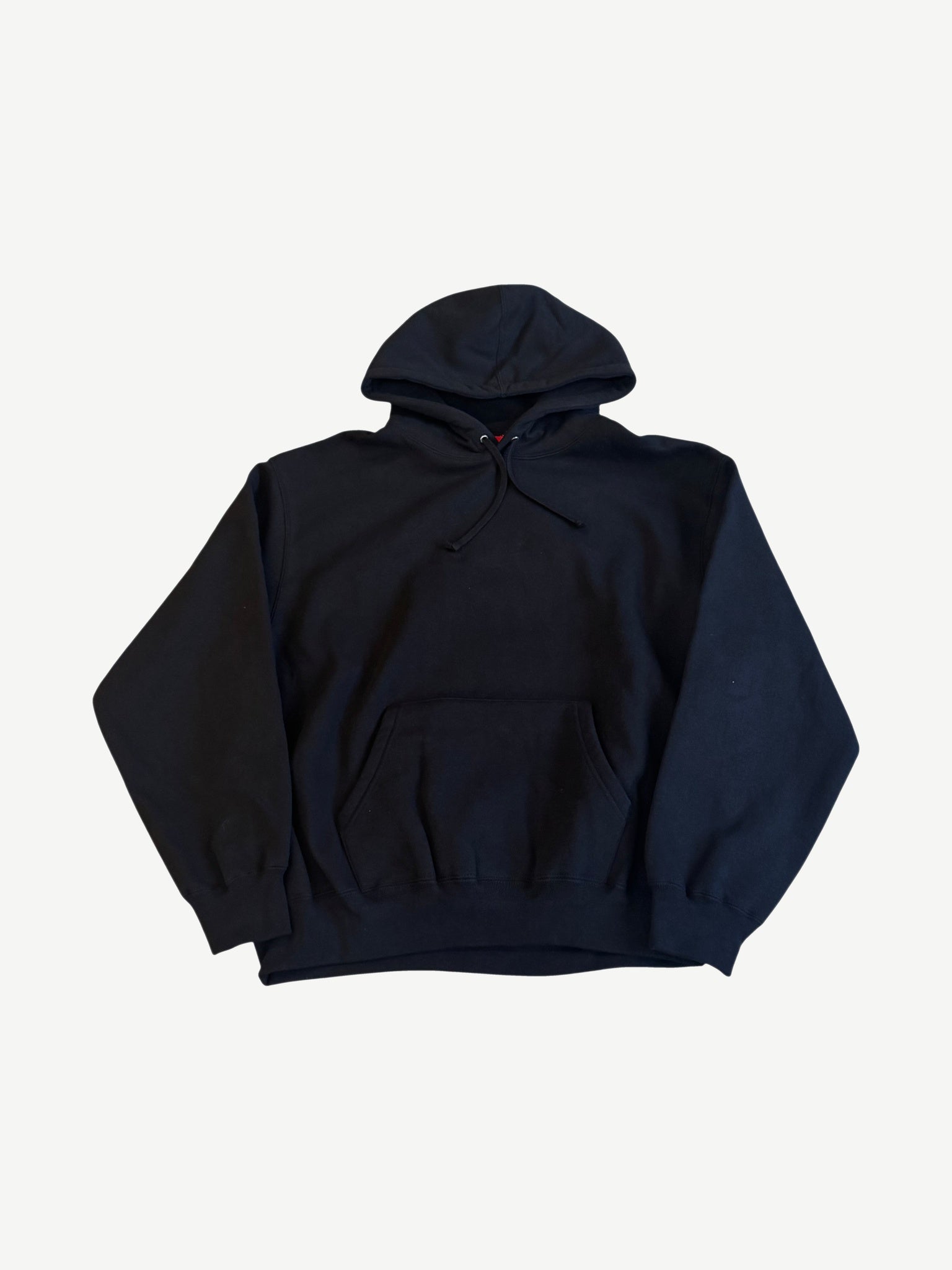 Supreme black satin applique hoodie front, plain black heavyweight cotton fleece with red kangaroo pouch tag.