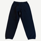 Supreme black satin sweatpants back view with patch pocket, elastic cuffs and clean tonal black fleece body