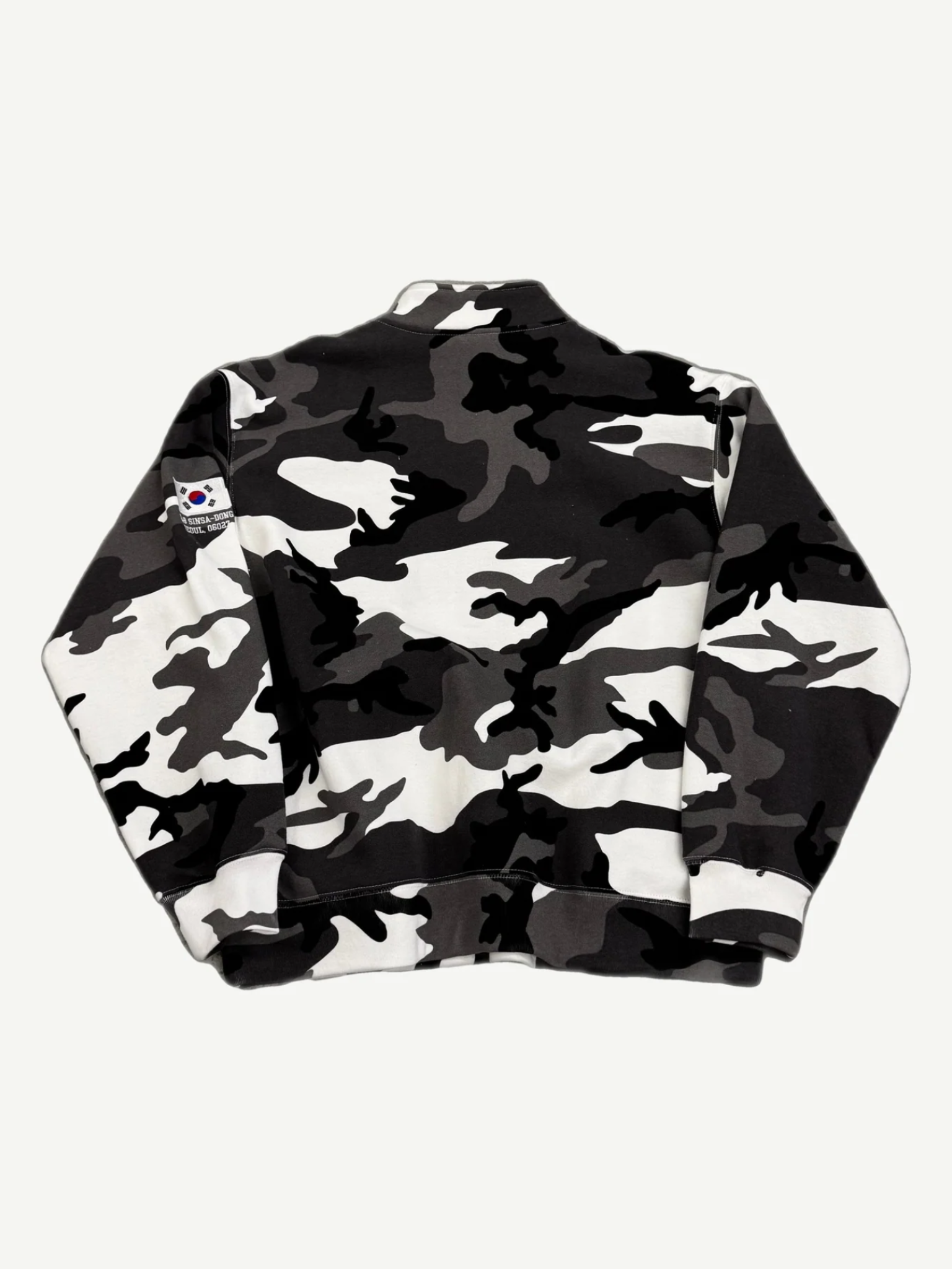 Supreme snow camo half-zip pullover back view with black and white camo print and sleeve patch detail