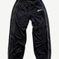Supreme black velour mesh track pants with white piping side stripes and script Supreme thigh logo.