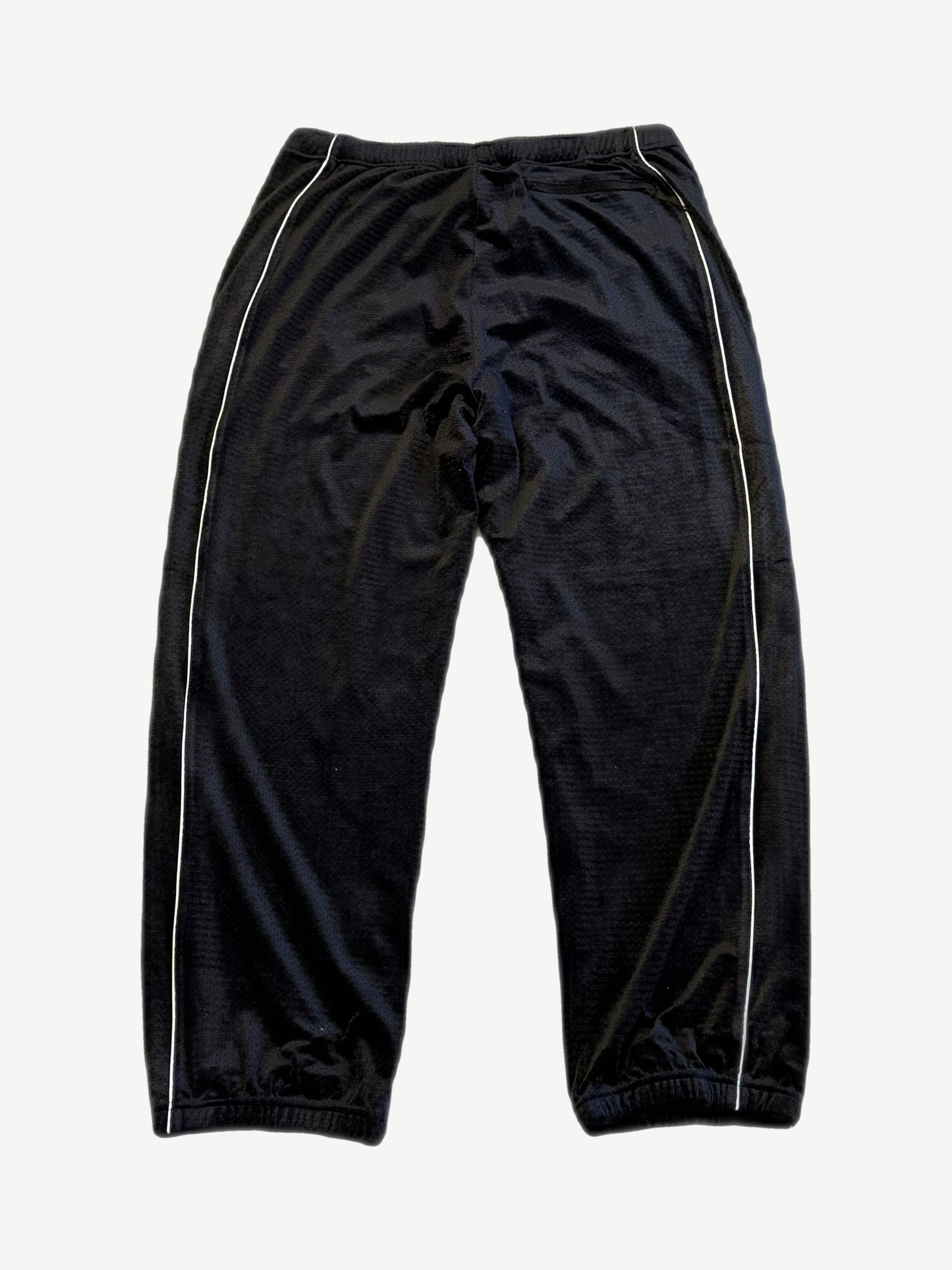 Supreme black velour mesh track pants back view with white side piping and elastic ankle cuffs.