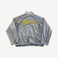 Supreme grey velour track jacket back view with yellow embroidered Supreme script across panel.