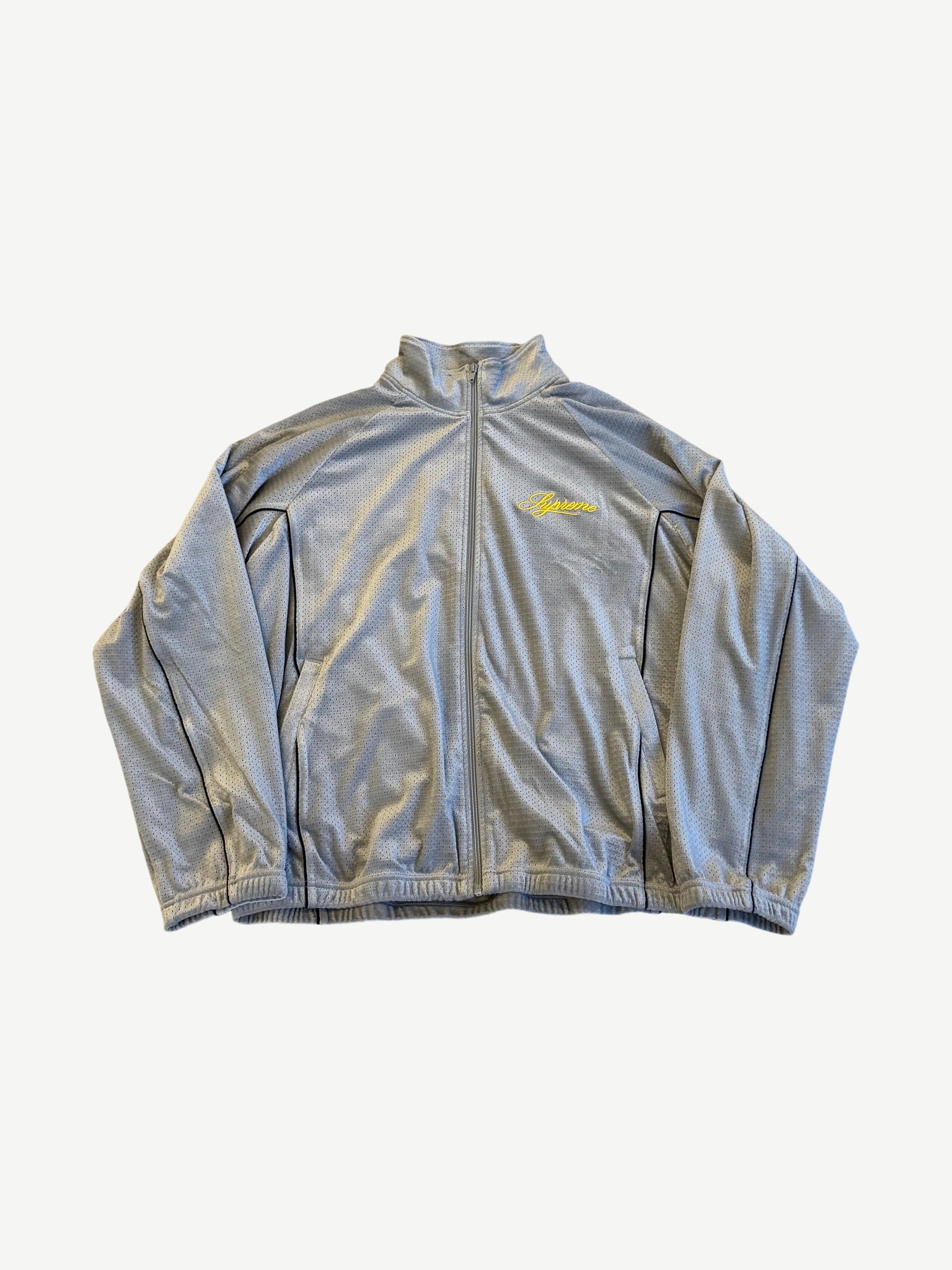Supreme grey velour mesh track jacket front view with full zip and yellow script chest logo.