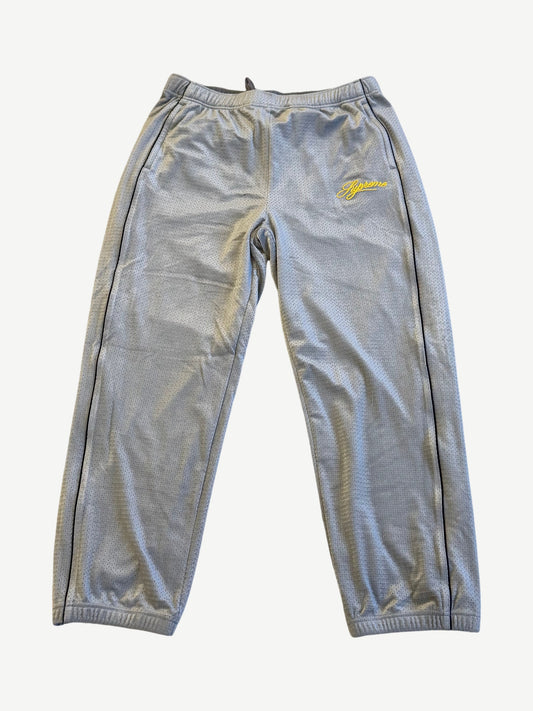 Supreme grey velour mesh track pants with yellow script logo at hip and black side piping