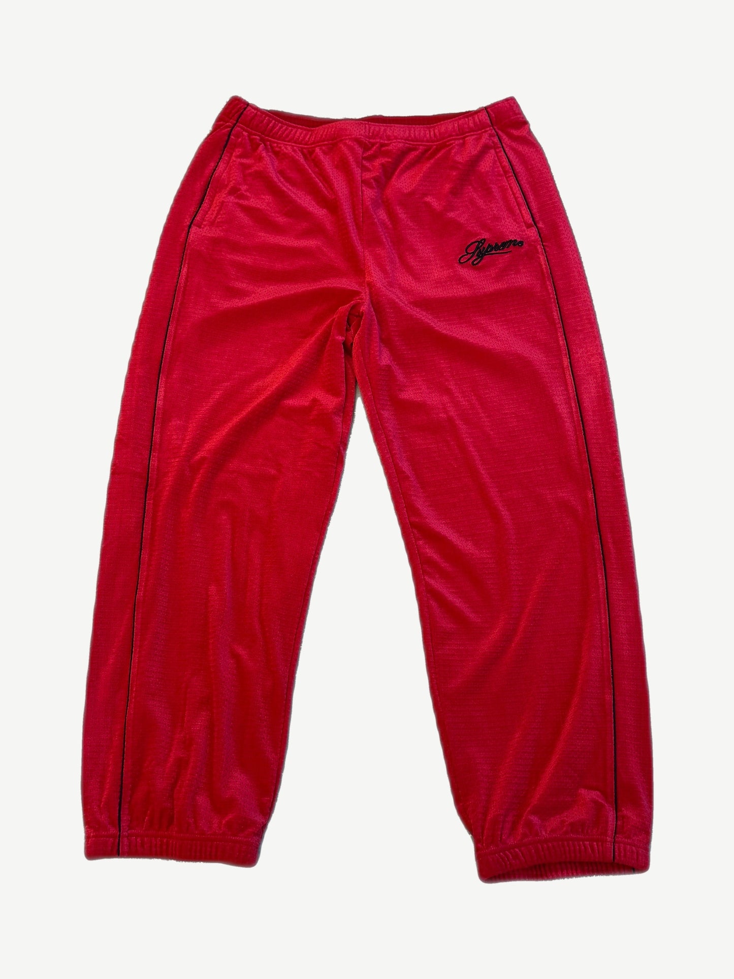 Supreme red velour mesh track pants with black side piping, elastic cuffs and embroidered Supreme script logo