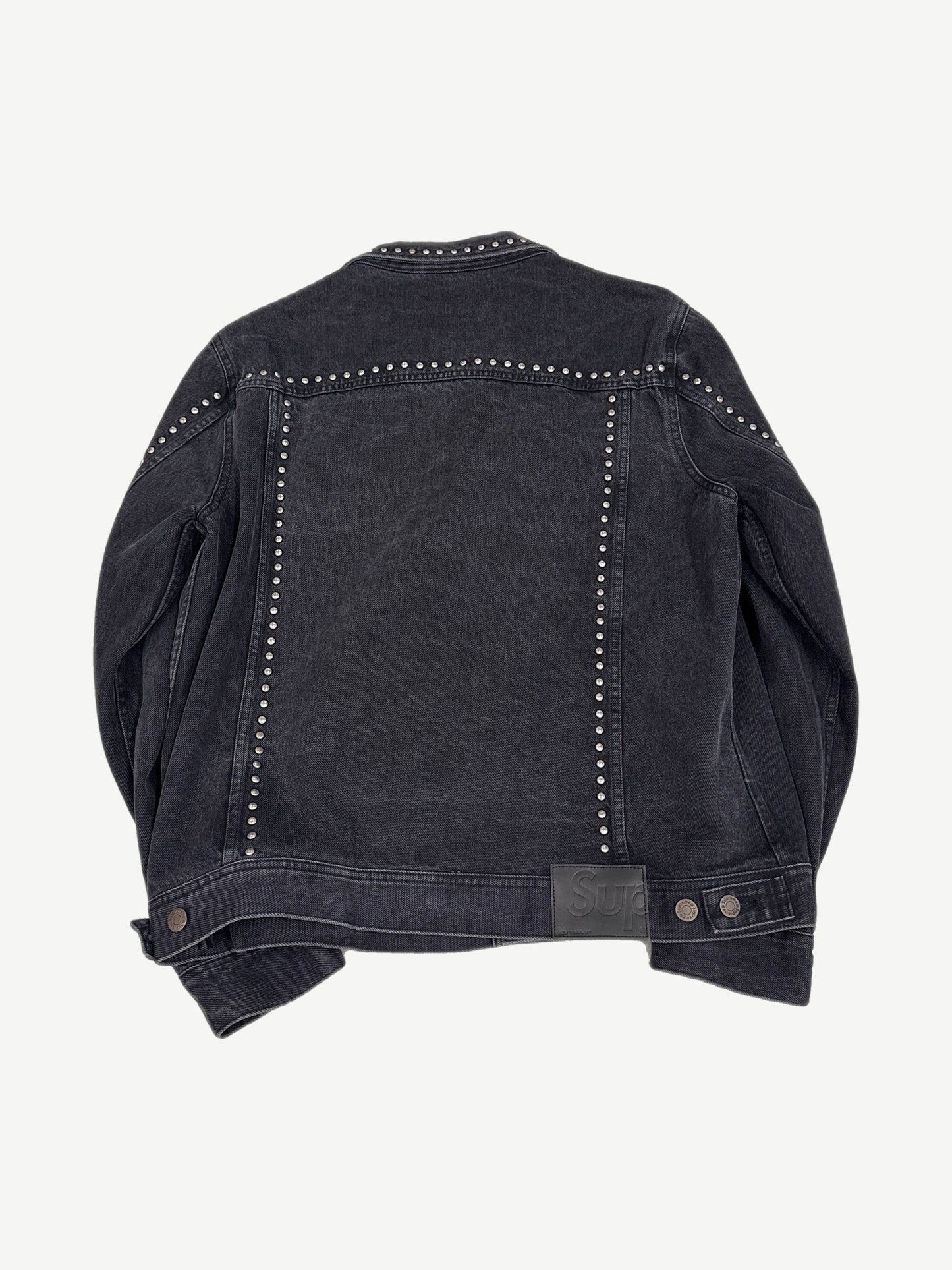 Supreme studded denim trucker jacket back view, indigo denim with stud embellishment and classic yoke seams.
