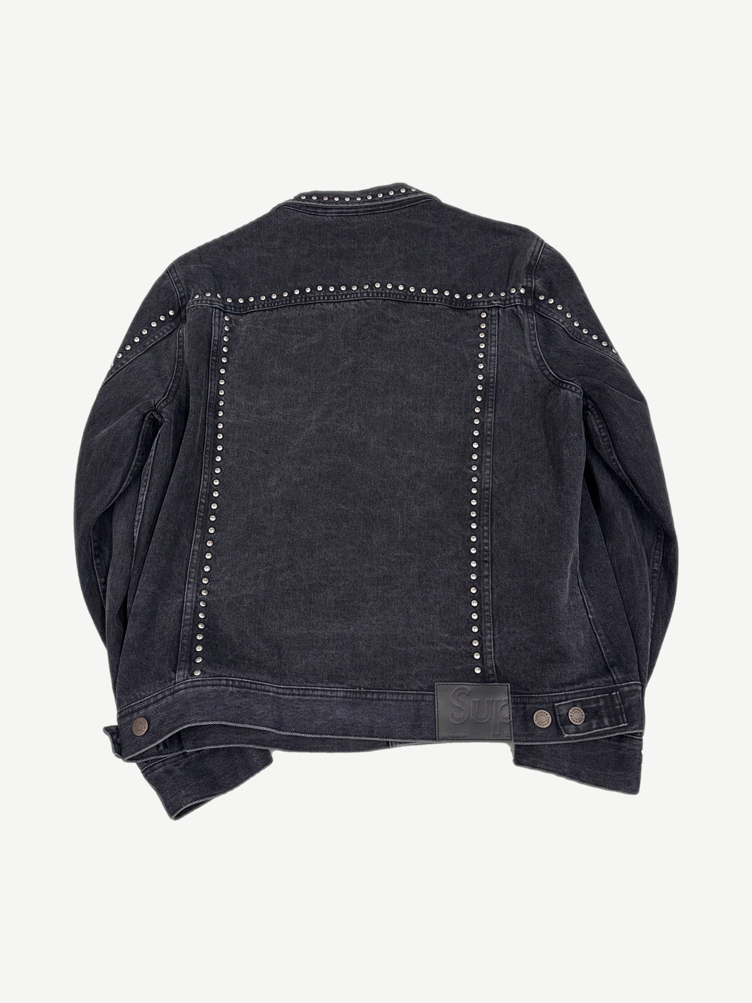 Supreme studded denim trucker jacket back view, indigo denim with stud embellishment and classic yoke seams.