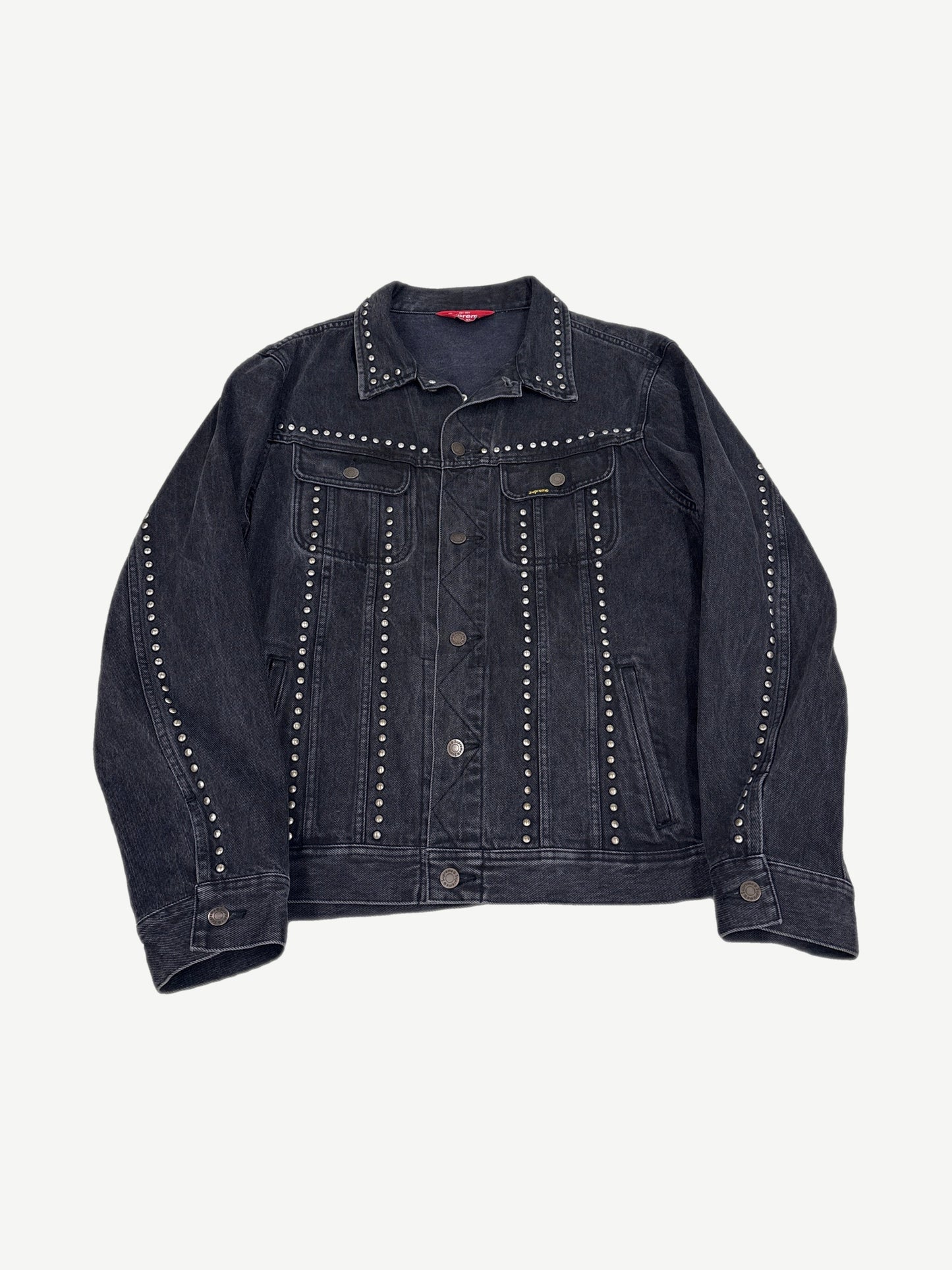 Supreme studded denim trucker jacket, indigo wash with silver pyramid stud detailing across chest and pockets.