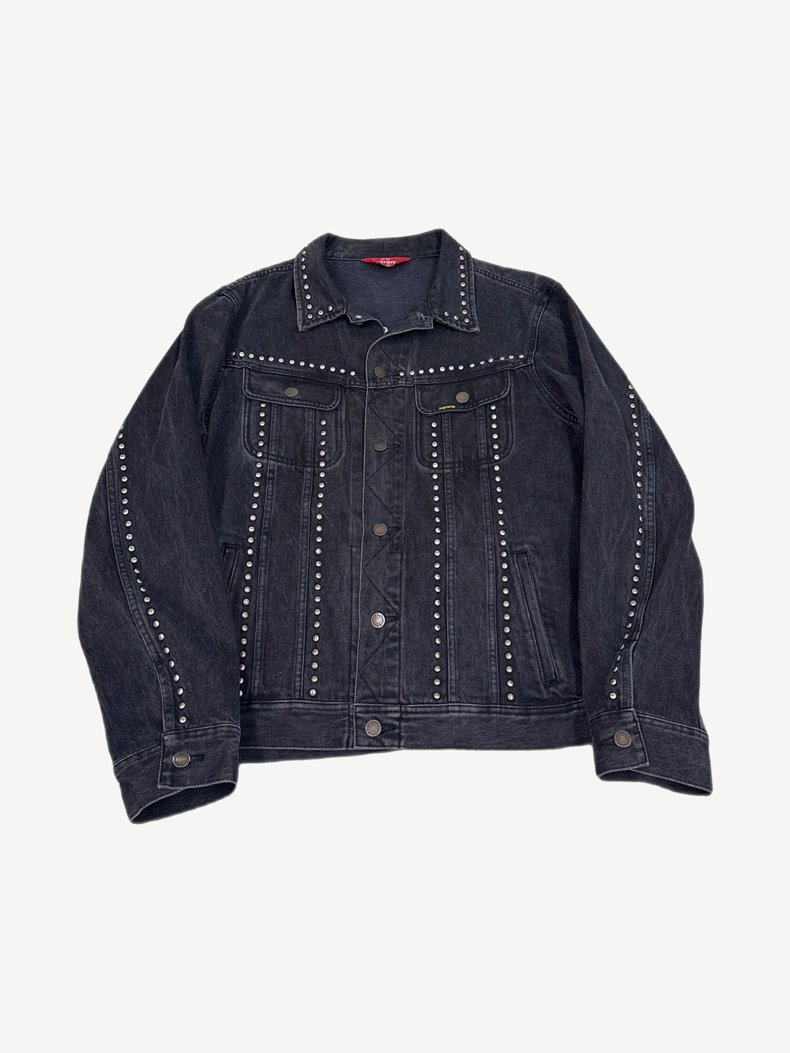 Supreme studded denim trucker jacket, indigo wash with silver pyramid stud detailing across chest and pockets.