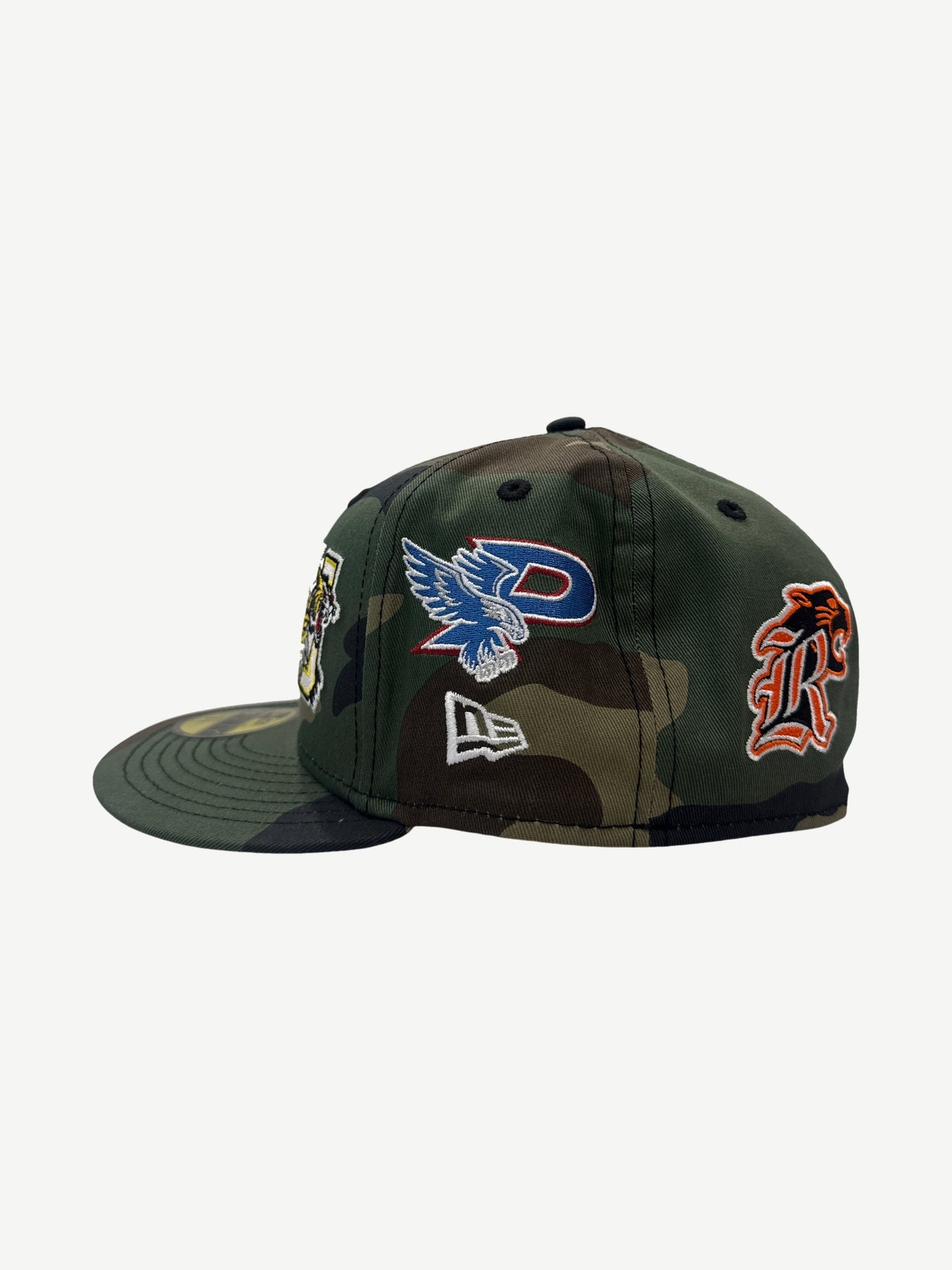 Supreme camo New Era fitted cap side view with embroidered eagle P, tiger and orange R mascot logos