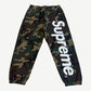 Supreme woodland camo sweatpants with large white satin applique Supreme logo down the leg