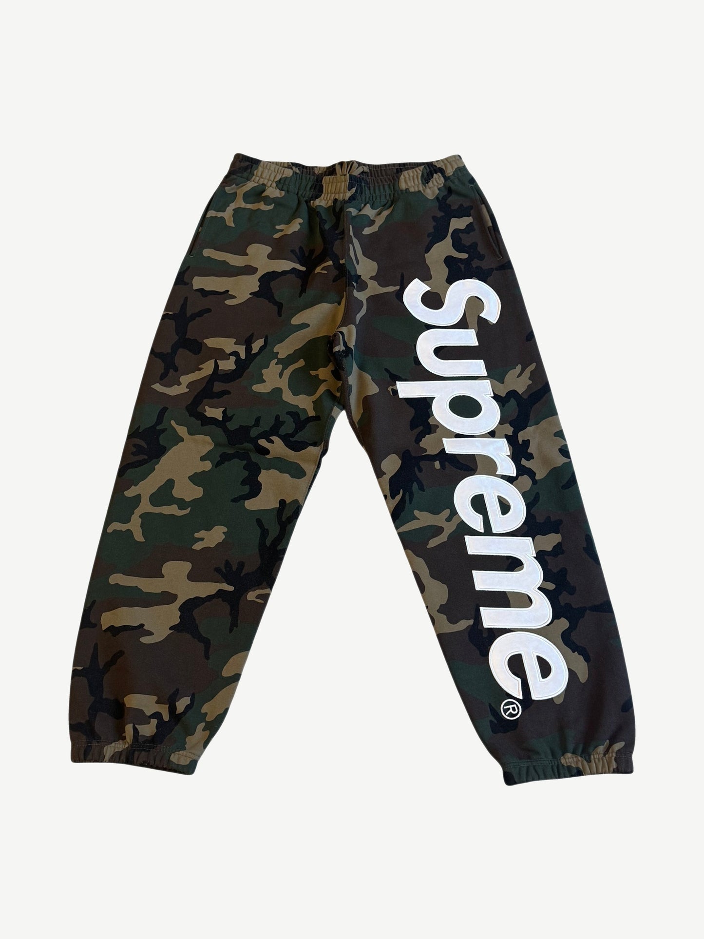 Supreme woodland camo sweatpants with large white satin applique Supreme logo down the leg