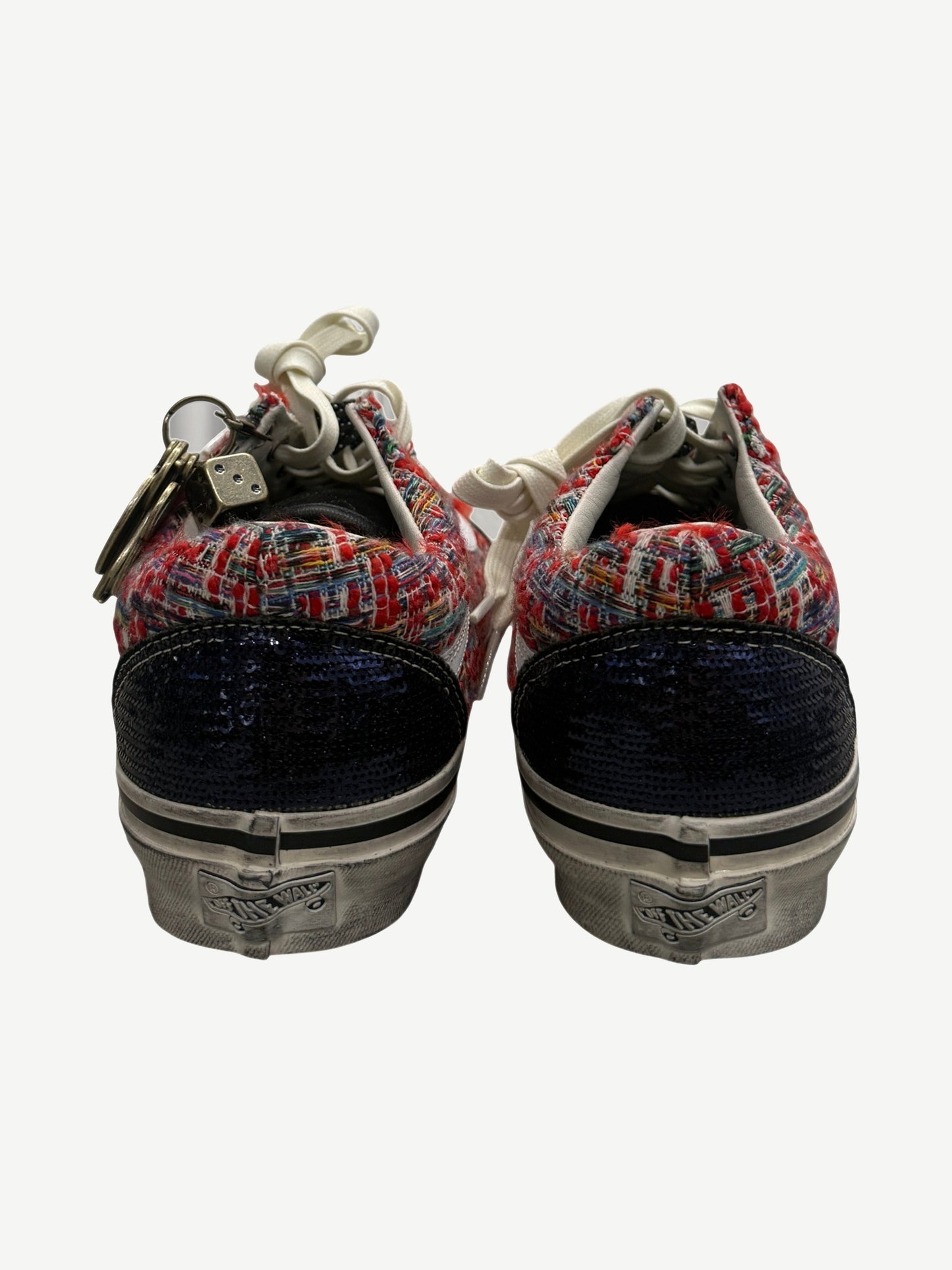 Heel view of Vans Old Skool sneakers showing navy sequin back panels and red tweed collar detail