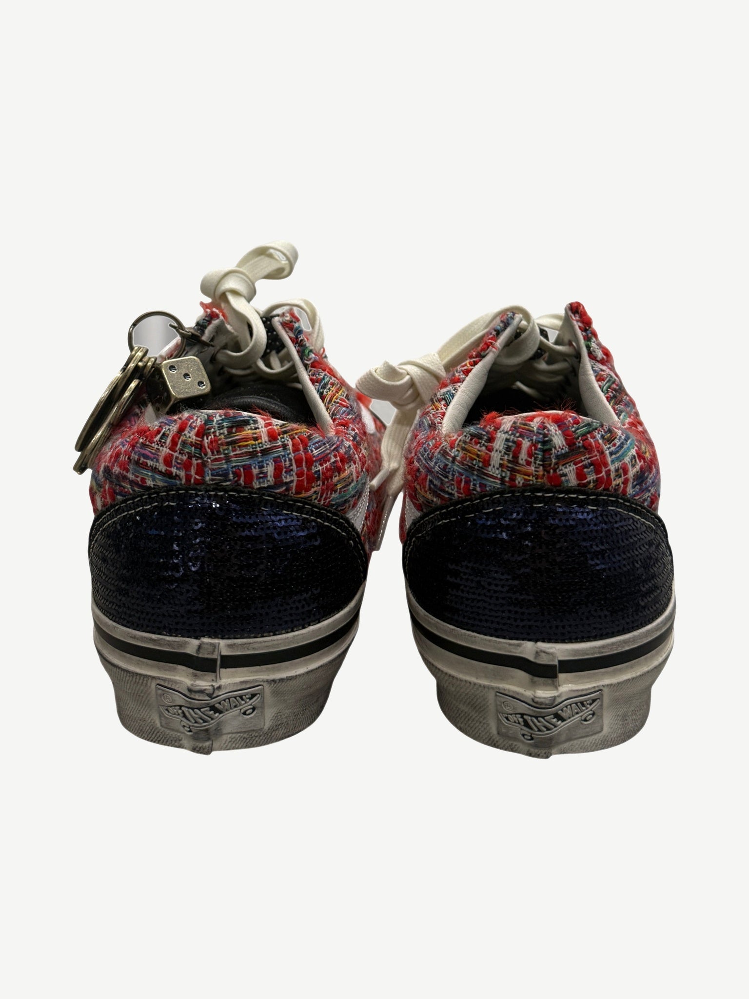 Heel view of Vans Old Skool sneakers showing navy sequin back panels and red tweed collar detail